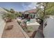 Beautiful aerial view of the backyard featuring an outdoor fireplace, patio, and lush landscaping at 20766 W White Rock Rd, Buckeye, AZ 85396