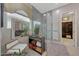 Modern bathroom with a glass-enclosed shower and a spacious walk-in closet at 20766 W White Rock Rd, Buckeye, AZ 85396