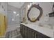 Bathroom featuring a vanity with dark cabinets, white countertops, and a shower/tub combo at 20766 W White Rock Rd, Buckeye, AZ 85396