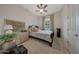 Serene bedroom featuring a comfortable bed, decorative dresser, and scenic window view at 20766 W White Rock Rd, Buckeye, AZ 85396