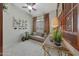 Cozy bonus room with a comfortable couch, ceiling fan, and window at 20766 W White Rock Rd, Buckeye, AZ 85396
