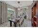 Formal dining room boasts elegant chandelier, plush seating, and large windows for ample natural light at 20766 W White Rock Rd, Buckeye, AZ 85396