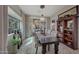 Elegant dining room with chandelier, large table with seating for six, and an arched nook at 20766 W White Rock Rd, Buckeye, AZ 85396