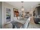 Spacious dining area with elegant chandelier, seating for six, and views into the kitchen at 20766 W White Rock Rd, Buckeye, AZ 85396