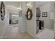 Inviting hallway leading to laundry with tile flooring and decorative mirror at 20766 W White Rock Rd, Buckeye, AZ 85396