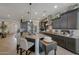 Well-appointed kitchen features stainless steel appliances, granite countertops, and an island with bar seating at 20766 W White Rock Rd, Buckeye, AZ 85396