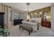 Luxurious main bedroom features a chandelier, textured wallpaper, and a plush seating bench at 20766 W White Rock Rd, Buckeye, AZ 85396