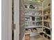 Walk-in pantry provides ample storage space with shelving for groceries and household items at 20766 W White Rock Rd, Buckeye, AZ 85396