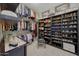 Organized walk-in closet with shelves, hanging rods, and a stylish ottoman at 20766 W White Rock Rd, Buckeye, AZ 85396