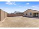 Dirt backyard with a block wall providing privacy at 2113 N 210Th Ave, Buckeye, AZ 85396