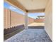 Covered patio with stone flooring in a backyard with block wall at 2113 N 210Th Ave, Buckeye, AZ 85396