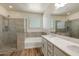 Bright bathroom with a glass-enclosed shower, soaking tub and double sinks with modern cabinetry at 2113 N 210Th Ave, Buckeye, AZ 85396