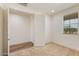 A simple yet light-filled bedroom boasts natural light, plush carpet, and ample closet space at 2113 N 210Th Ave, Buckeye, AZ 85396