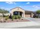 Charming single-story home with a well-manicured front yard and a two-car garage at 2113 N 210Th Ave, Buckeye, AZ 85396