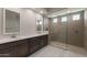 Modern bathroom with dual sinks, granite countertops, and a spacious glass-enclosed shower at 26161 S 225Th Way, Queen Creek, AZ 85142