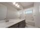 Bright bathroom featuring double sinks, a large mirror, and a shower-tub combination for a modern and functional design at 26161 S 225Th Way, Queen Creek, AZ 85142