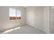 Well-lit bedroom featuring neutral carpet, a large window, and a closet, creating a cozy and inviting atmosphere at 26161 S 225Th Way, Queen Creek, AZ 85142