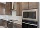 Modern kitchen featuring stainless steel appliances, granite countertops, and wooden cabinets at 26161 S 225Th Way, Queen Creek, AZ 85142