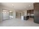 Open-concept kitchen and living area with a kitchen island and sliding glass doors to the patio at 26161 S 225Th Way, Queen Creek, AZ 85142