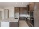 Contemporary kitchen featuring dark cabinetry, stainless steel appliances, and a large center island at 26161 S 225Th Way, Queen Creek, AZ 85142