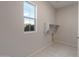 Bright laundry room featuring tile flooring, utility connections, and a window that provides plenty of natural light at 26161 S 225Th Way, Queen Creek, AZ 85142