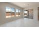 Bright living room with tile flooring and multiple windows offering backyard views at 26161 S 225Th Way, Queen Creek, AZ 85142