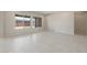 Sunlit living room with large windows, neutral paint, and sleek tile flooring throughout the space at 26161 S 225Th Way, Queen Creek, AZ 85142
