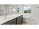 Luxurious bathroom with double vanity, soaking tub and glass enclosed shower at 2681 N Riverside Dr, Florence, AZ 85132