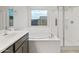 Bright bathroom featuring a soaking tub, glass shower and double vanity sinks at 2681 N Riverside Dr, Florence, AZ 85132