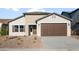 Charming single-story home featuring a two-car garage and neutral-toned stucco with low-maintenance desert landscaping at 2681 N Riverside Dr, Florence, AZ 85132