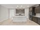 Spacious kitchen featuring gray cabinets, stainless steel appliances, a center island with white countertop, and travertine tile at 2681 N Riverside Dr, Florence, AZ 85132