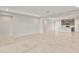 Open living space with travertine tile, neutral walls, and an open floor plan connecting to the kitchen at 2681 N Riverside Dr, Florence, AZ 85132