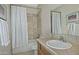 Well-lit bathroom featuring tiled walls, a vanity with a sink, and a shower-tub combination at 30066 N Holly Dr, San Tan Valley, AZ 85144