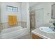 Bathroom features a shower, a soaking tub, tile flooring, and neutral paint at 30066 N Holly Dr, San Tan Valley, AZ 85144