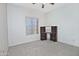 Simple bedroom featuring a desk and natural light from a window, ideal for a home office or guest room at 30066 N Holly Dr, San Tan Valley, AZ 85144