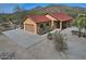 Inviting single-story home with a spacious driveway, two-car garage, and mountain views at 30066 N Holly Dr, San Tan Valley, AZ 85144