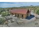 A beautiful desert home featuring a cozy covered patio, desert landscaping, and scenic mountain views in the background at 30066 N Holly Dr, San Tan Valley, AZ 85144