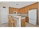 Functional kitchen area with wooden cabinets, a breakfast bar, and modern appliances at 30066 N Holly Dr, San Tan Valley, AZ 85144