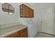 Laundry room featuring tile floors, ample cabinet space, and a window for natural light at 30066 N Holly Dr, San Tan Valley, AZ 85144