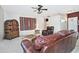 Warm living room with leather furniture, a patterned wall hanging, and a view into other rooms at 30066 N Holly Dr, San Tan Valley, AZ 85144