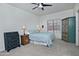 Comfortable bedroom featuring a ceiling fan, neutral carpet, and rustic furnishings at 30066 N Holly Dr, San Tan Valley, AZ 85144