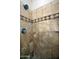 Beautifully tiled shower with designer accent strip at 30066 N Holly Dr, San Tan Valley, AZ 85144