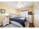 Cozy bedroom with a ceiling fan, a comfortable bed, and natural light from the window at 3245 N 147Th Ln, Goodyear, AZ 85395