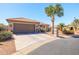 Well-maintained home with mature palm trees, desert landscaping, and a spacious driveway at 3245 N 147Th Ln, Goodyear, AZ 85395