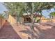 Expansive backyard featuring desert landscaping, mature trees, and a covered patio for relaxed outdoor enjoyment at 325 W Seaside Dr, Casa Grande, AZ 85122