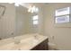 Bright bathroom featuring a double sink vanity, large mirror, and ample lighting at 325 W Seaside Dr, Casa Grande, AZ 85122