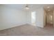 Neutral carpeted bedroom showing bathroom entrance and hallway access at 325 W Seaside Dr, Casa Grande, AZ 85122