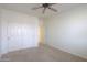 Spacious bedroom featuring carpet flooring, a closet, and a ceiling fan at 325 W Seaside Dr, Casa Grande, AZ 85122