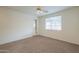 Bright bedroom featuring neutral carpet and a window with backyard view at 325 W Seaside Dr, Casa Grande, AZ 85122