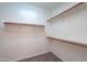Walk-in closet with wood shelves and carpeted floor at 325 W Seaside Dr, Casa Grande, AZ 85122